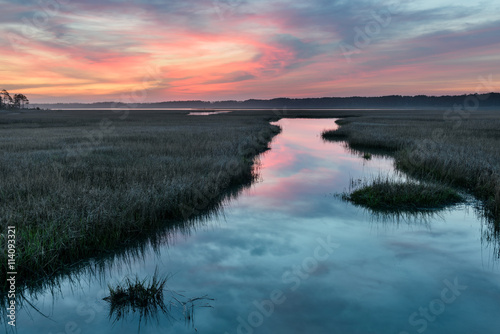 Colorful Sunrise Over Inlet with Water Reflections