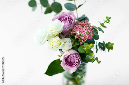 Bouquet of roses in vase on the white background © Africa Studio
