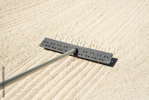 Raking a golf bunker