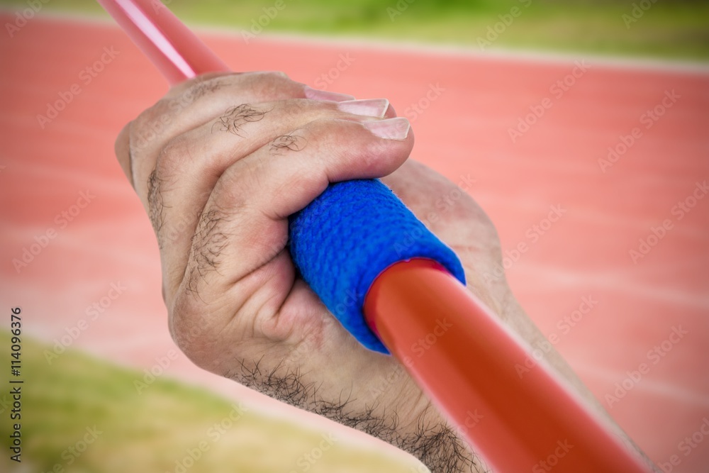 Composite image of close-up of hand holding javelin Composite image of close-up of hand holding javelin