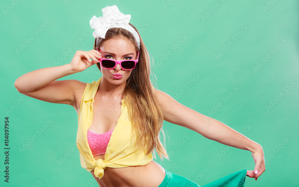 Portrait of happy pin up girl wearing sunglasses.