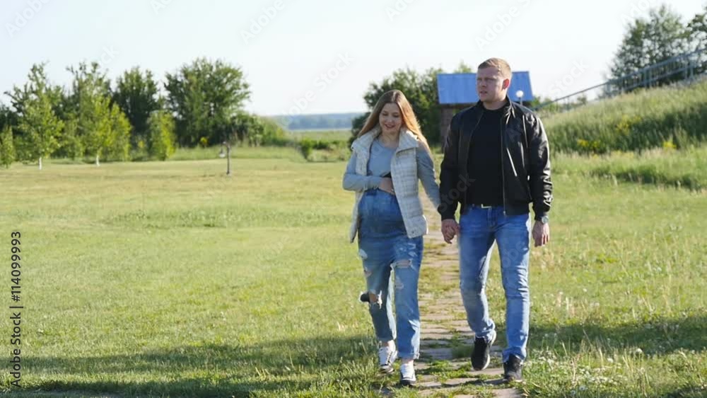 Pregnant woman with husband walking