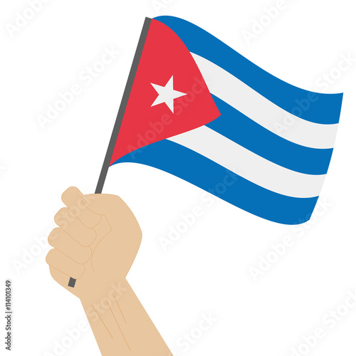 Hand holding and raising the national flag of Cuba