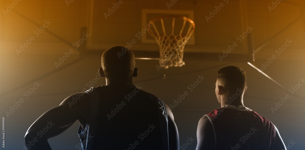 Fototapeta premium Two basketball player looking the basketball hoop