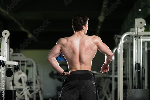 Young Bodybuilder Flexing Back Pose