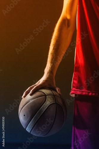 Photography Close up on basketball held by basketball player