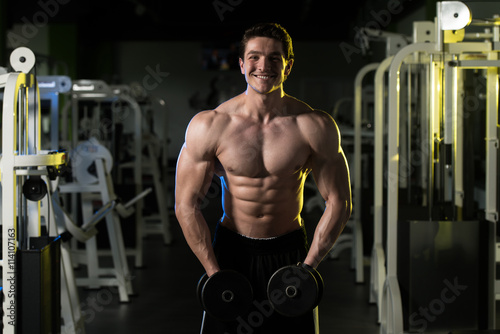 Fitness Man Doing Exercise With Dumbbells Shoulders © Jale Ibrak