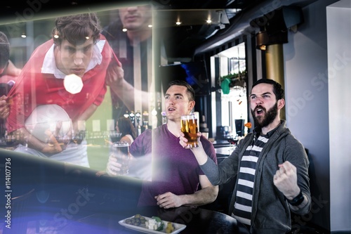 Composite image of friends are watching rugby match 