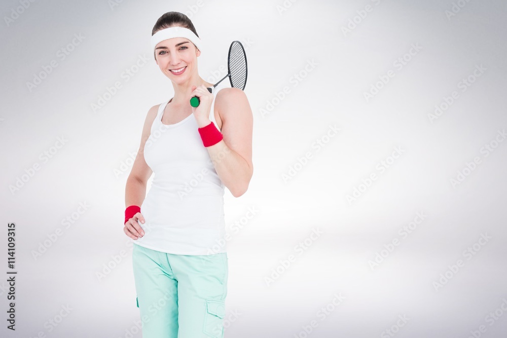 Composite image of badminton player is posing and smiling Composite image of badminton player is posing and smiling