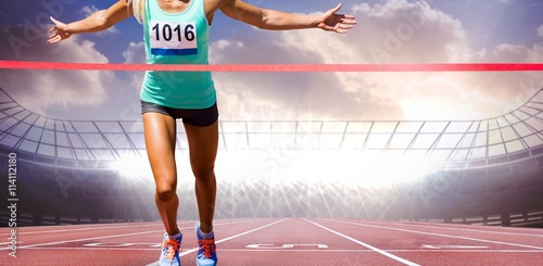 Фототапет Composite image of sportswoman finishing her run