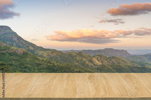 Wood floor with background of mountain view at twilight