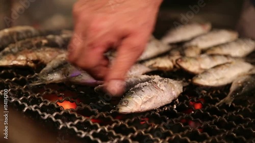 Fresh fish on the grill with smoke photo
