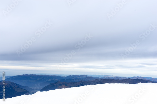 snow scene on alpes mountains in cloud sky