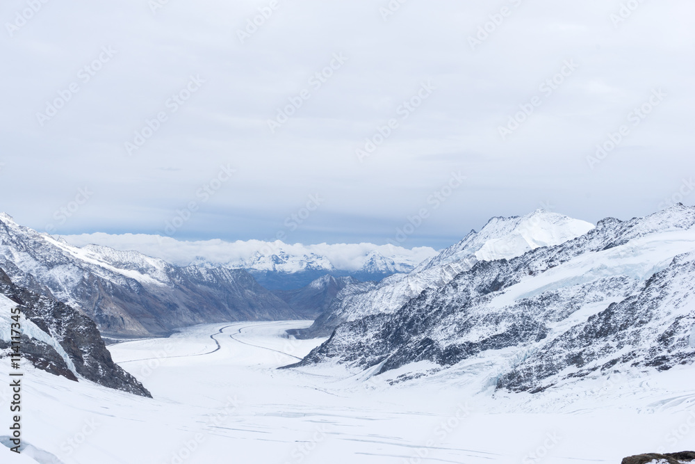 snow scene on alpes mountains in cloud sky