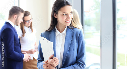 Face of beautiful woman on the background of business people © ty