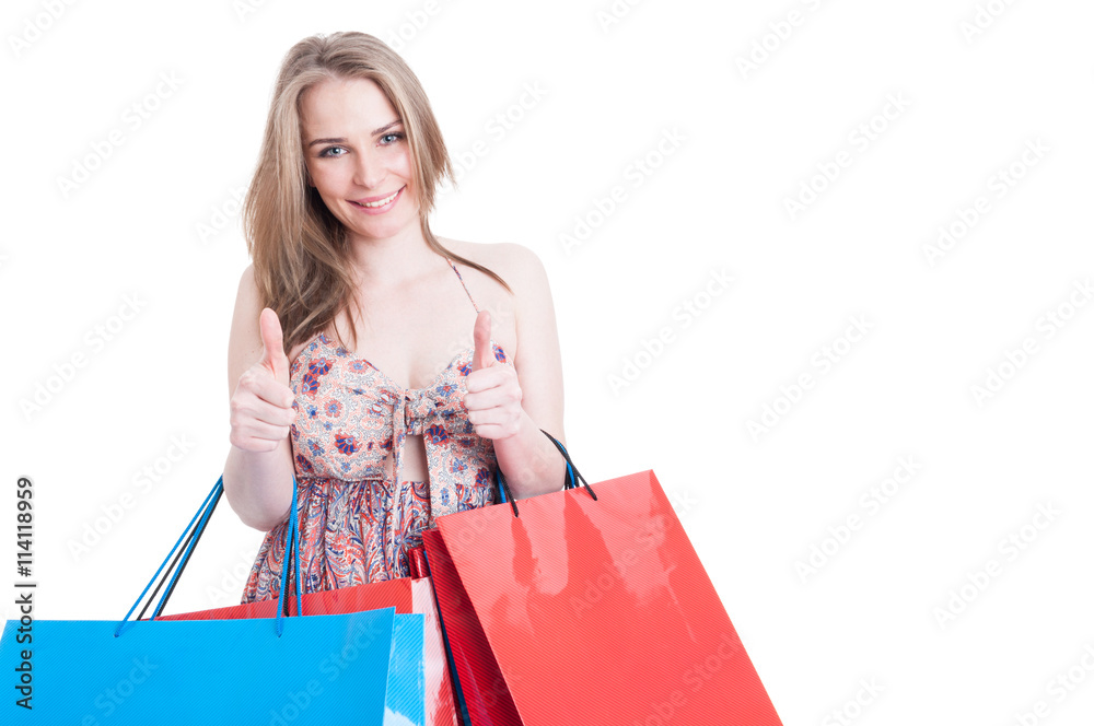 Shopping woman holding bags and showing double like gesture Shopping woman holding bags and showing double like gesture