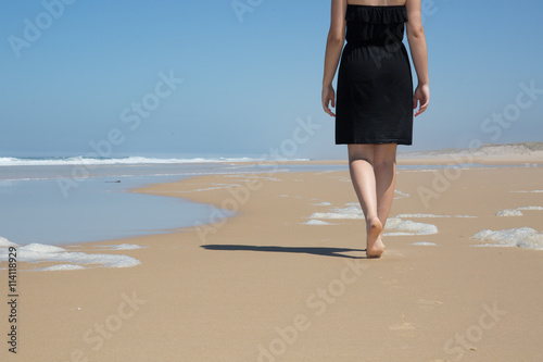 Caucasian woman walks along beautiful seashore © OceanProd