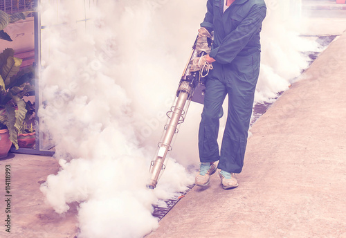 Soft focus the man fogging to eliminate mosquito for prevent spread dengue fever