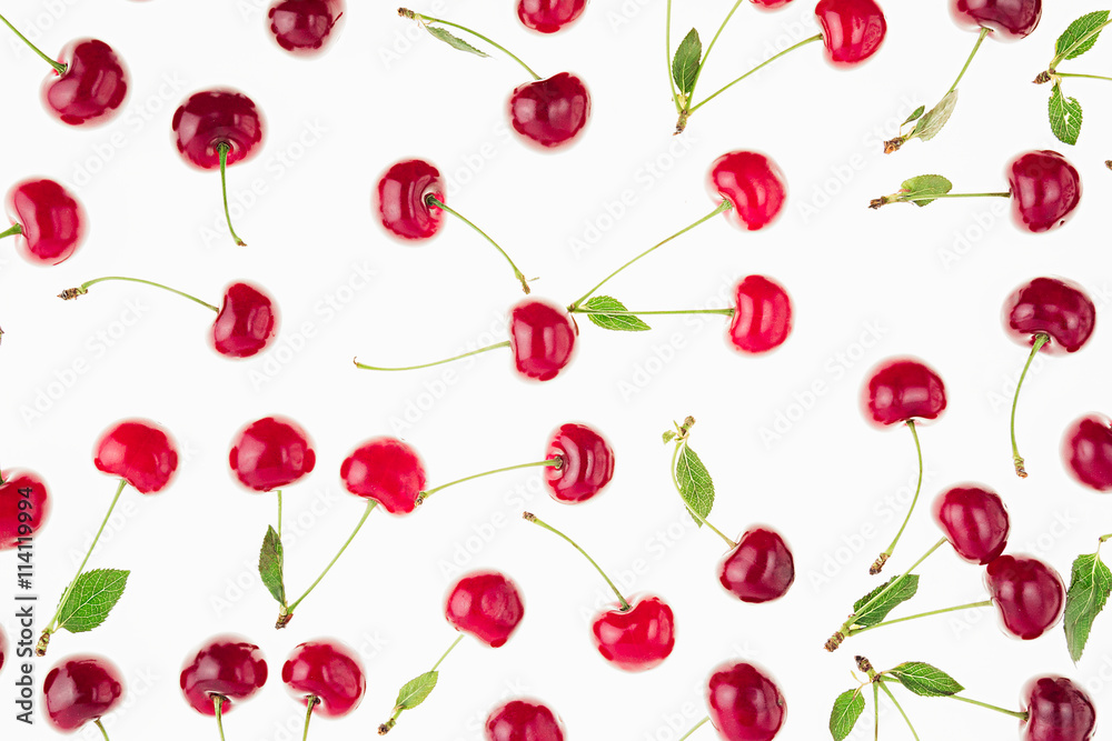 Scattered fresh ripe cherries with tails, leaves on a white background. Cherry background. Fruit background. Scattered fresh ripe cherries with tails, leaves on a white background. Cherry background. Fruit background.
