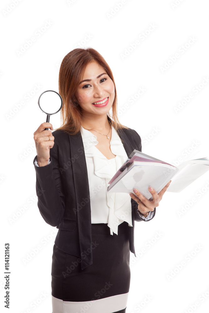 Asian business woman with a book and magnifying glass Asian business woman with a book and magnifying glass