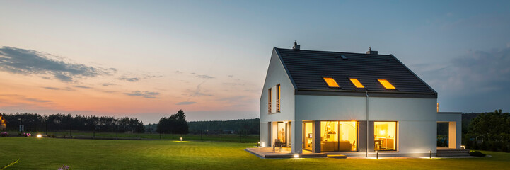 Modern house with garden at night