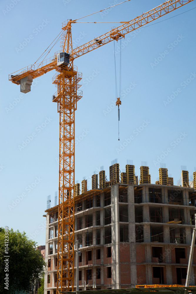 hoisting crane builds the house