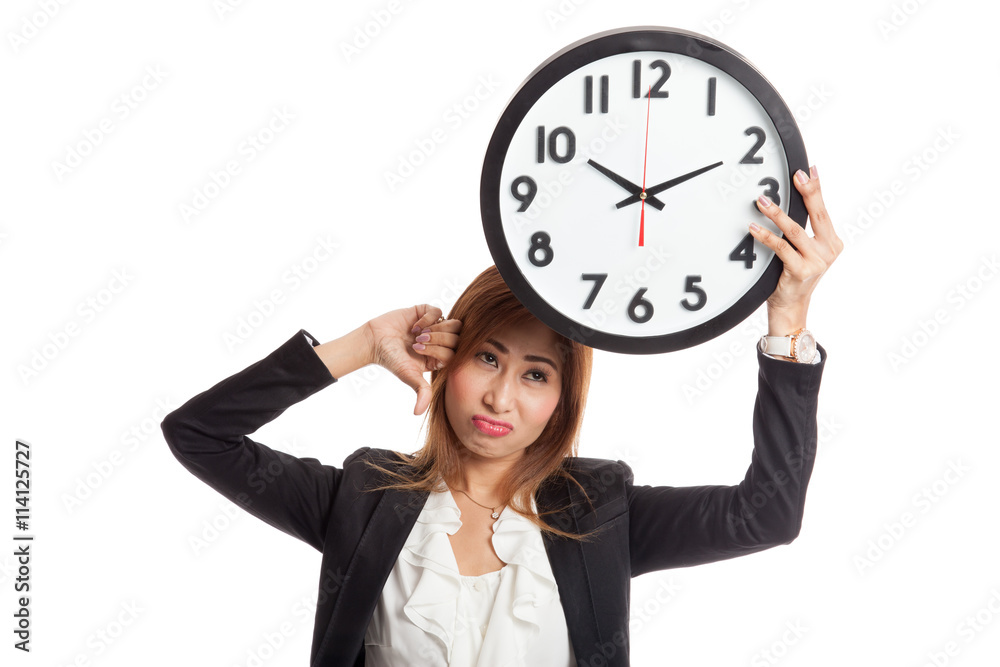 Young Asian business woman thumbs down with a clock Young Asian business woman thumbs down with a clock