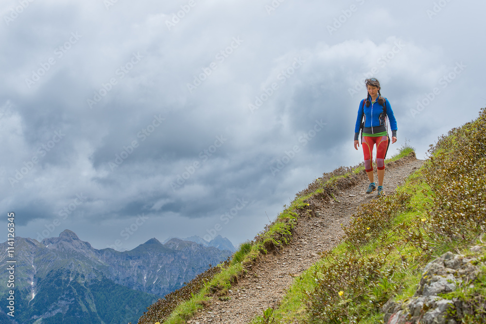 Girl mountain trail walks alone