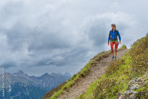 Girl mountain trail walks alone