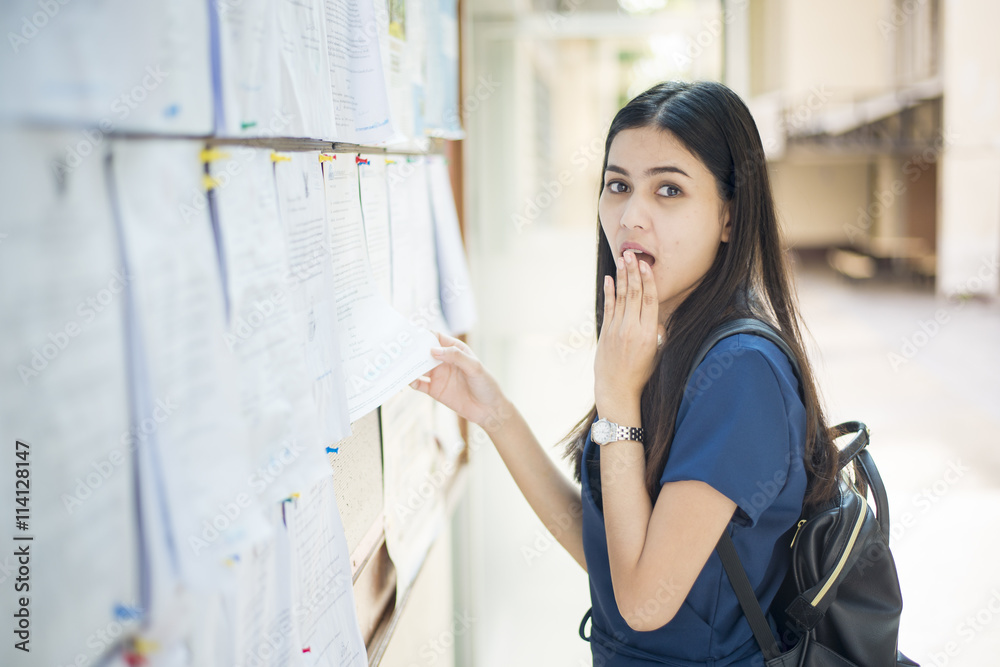 A female university student is exciting with the exam report A female university student is exciting with the exam report