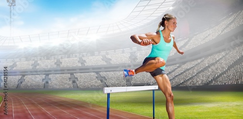 Composite image of sportswoman practising the hurdles © vectorfusionart