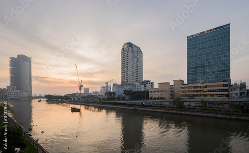 Ho Chi Minh, Vietnam - June 19, 2016: Beautiful sunrise over downtown of Ho Chi Minh City central with Historical Mong Bridge connect traffic between District 1 and District 4. © tonyng