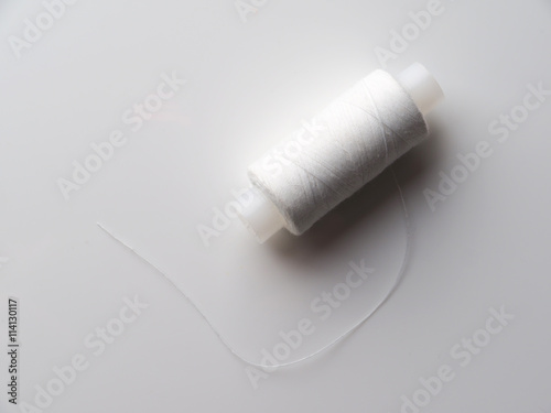 white thread on a gray background