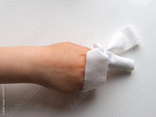 bandaged finger on a gray background