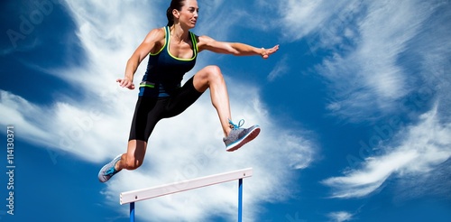 Composite image of athletic woman doing show jumping