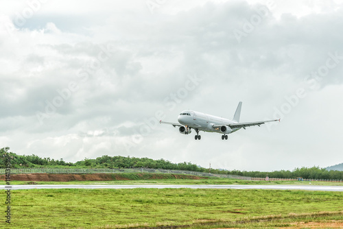 Airplane is landing on the airport before a storm approaching.