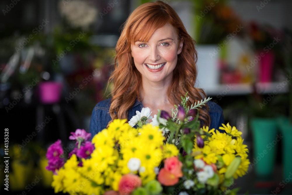 Female florist standing and smiling