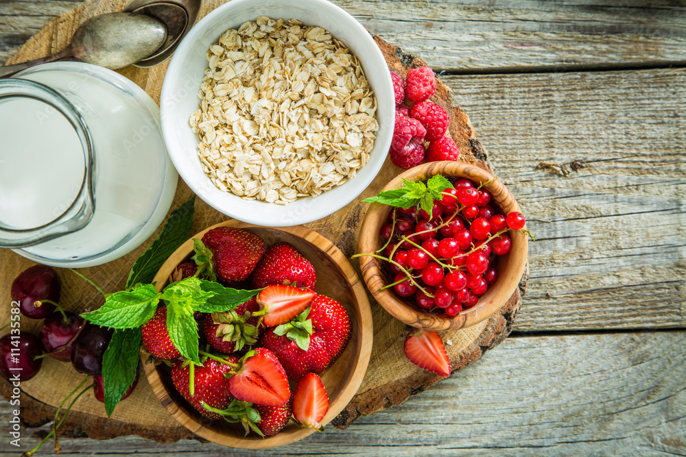 Oatmeal with berries on rustic wood background Oatmeal with berries on rustic wood background