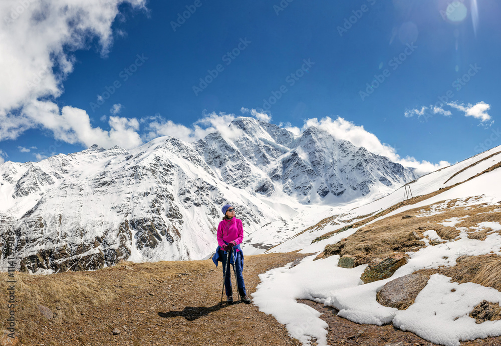 Tourists woman have a rest, Donguz-Orun 4468 m and Nakra Tau 4277 m peaks in Elbrus region, Caucasus, Russia Tourists woman have a rest, Donguz-Orun 4468 m and Nakra Tau 4277 m peaks in Elbrus region, Caucasus, Russia