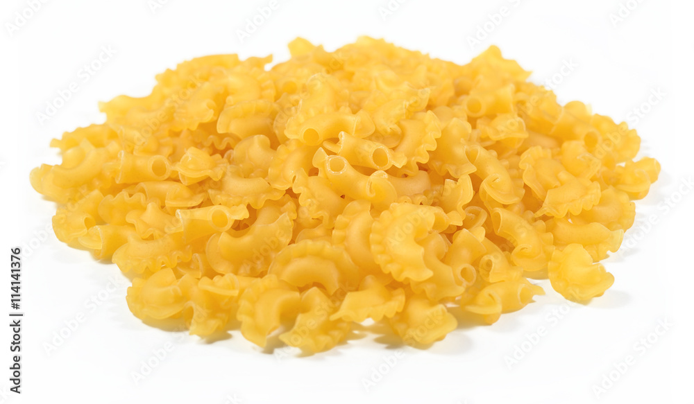 Heap of uncooked italian pasta on a white Heap of uncooked italian pasta on a white