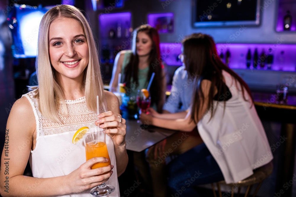 Portrait of beautiful woman having a cocktail 