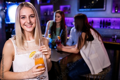 Portrait of beautiful woman having a cocktail 