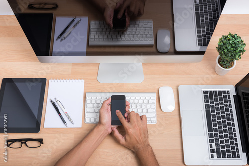 Top view hands of people working with mobile phone