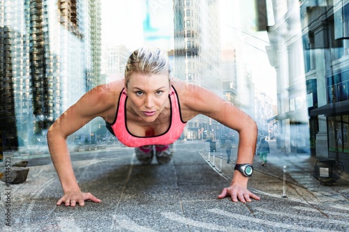 Composite image of a pretty woman doing push-ups on the floor
