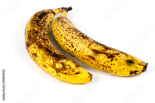 Two overripe bananas isolated on white background photo