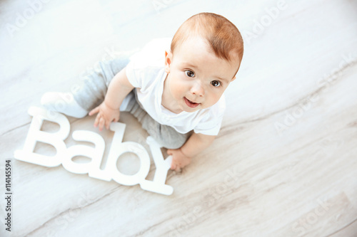 Cute baby boy with wooden w...