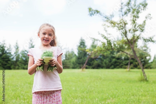 Girl outdoors with soft toy