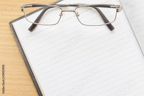 Notebook open blank page and Eyeglasses