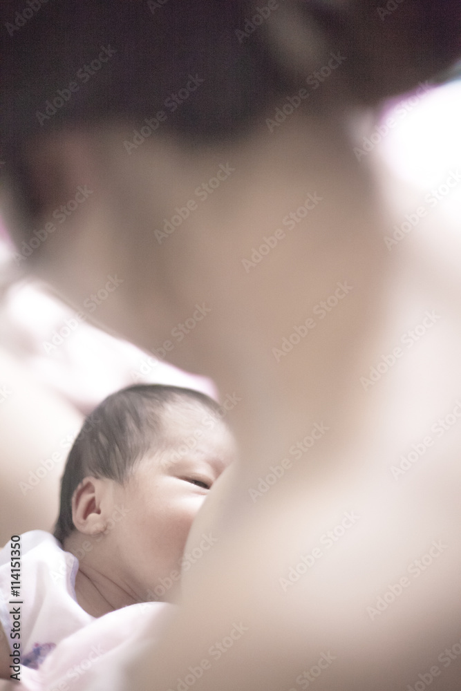 Sleepy baby breastfeeding her mother Sleepy baby breastfeeding her mother