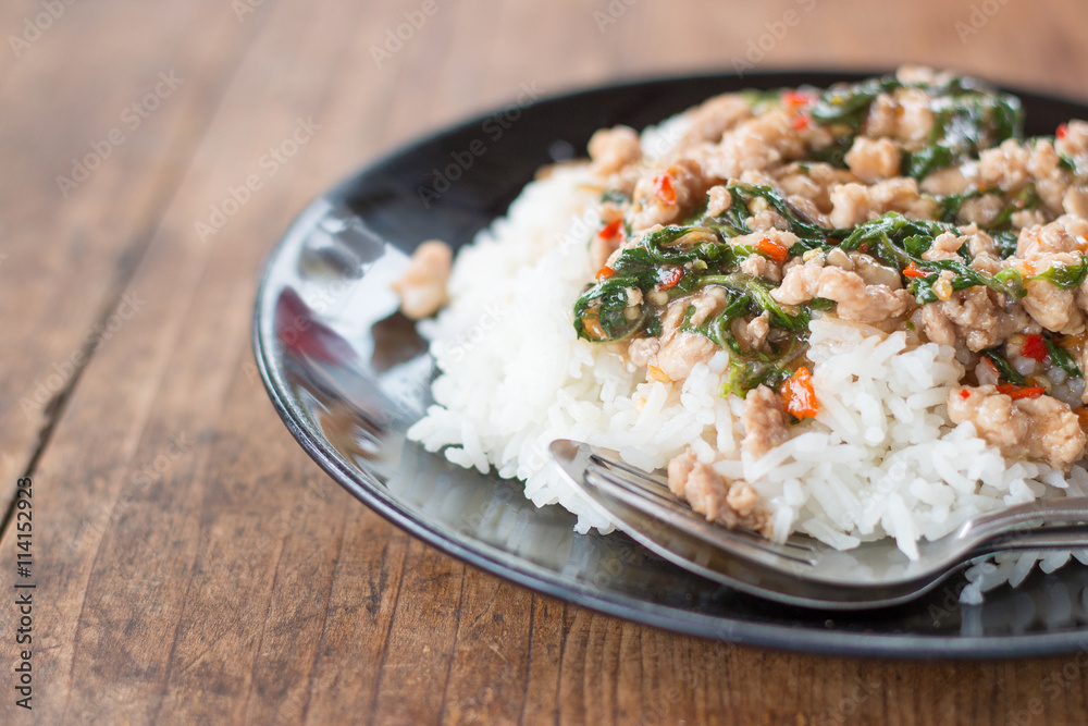 Thai food, rice topped with stir-fried pork and basil. Thai food, rice topped with stir-fried pork and basil.